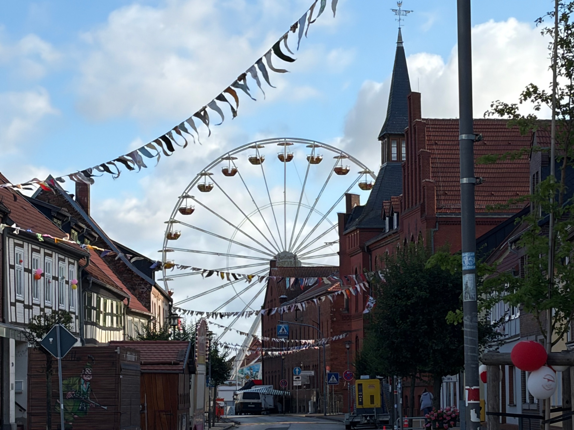 View of the festival grounds in the city center, with a Ferris wheel in the background