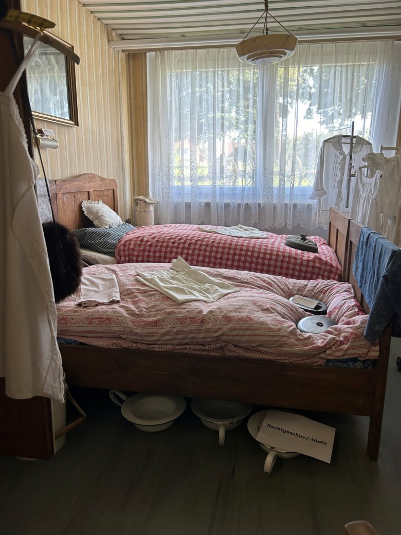 Old marriage bed in the refurbished bedroom with bedpan, thick beds and accessories in the Bretsch local history museum